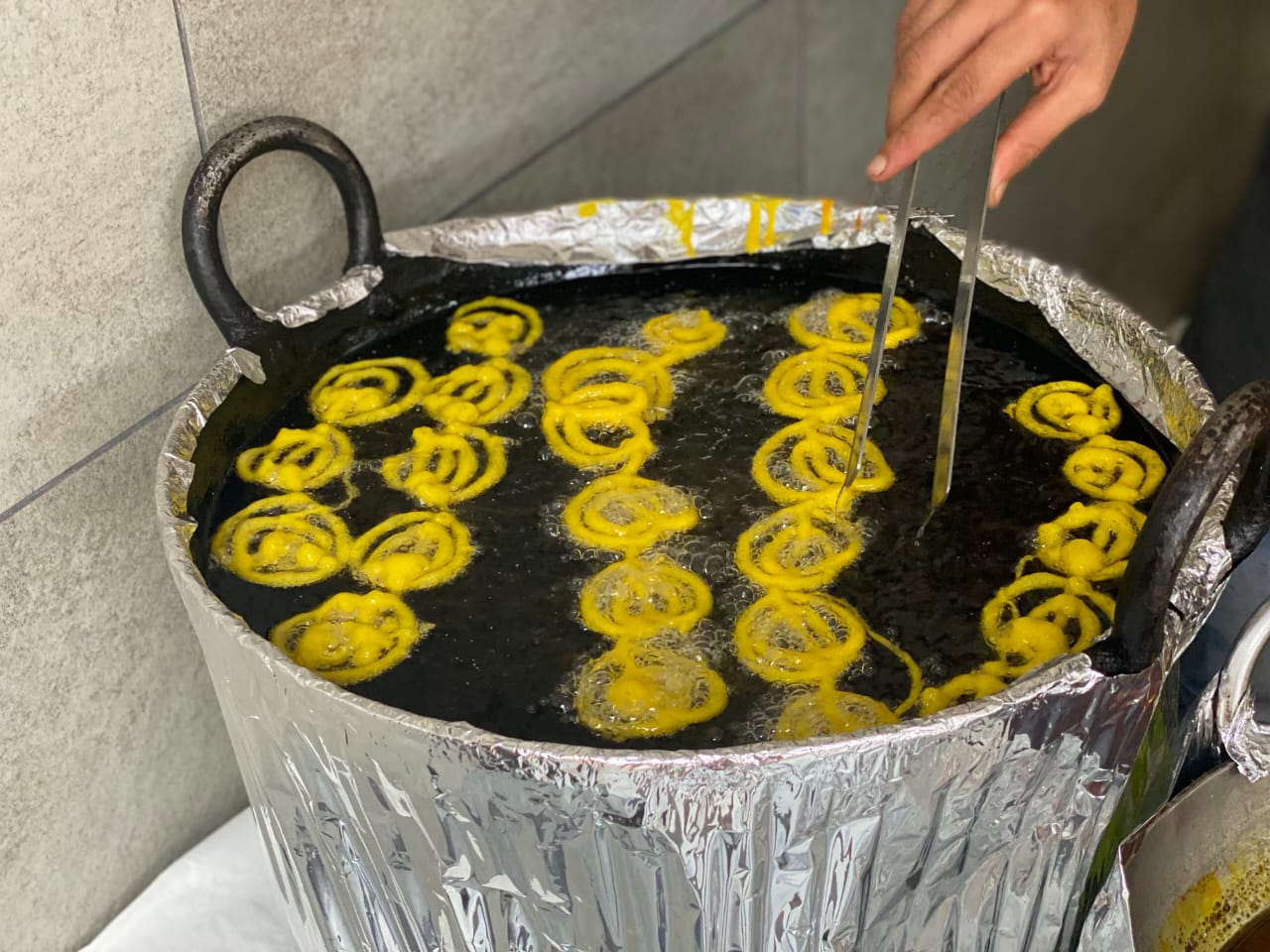 Fresh jalebi being prepared in a traditional kadai